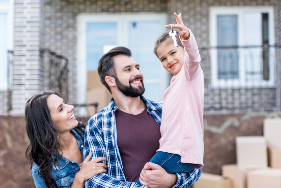 Family Standing in Front of House, Child Holding Keys